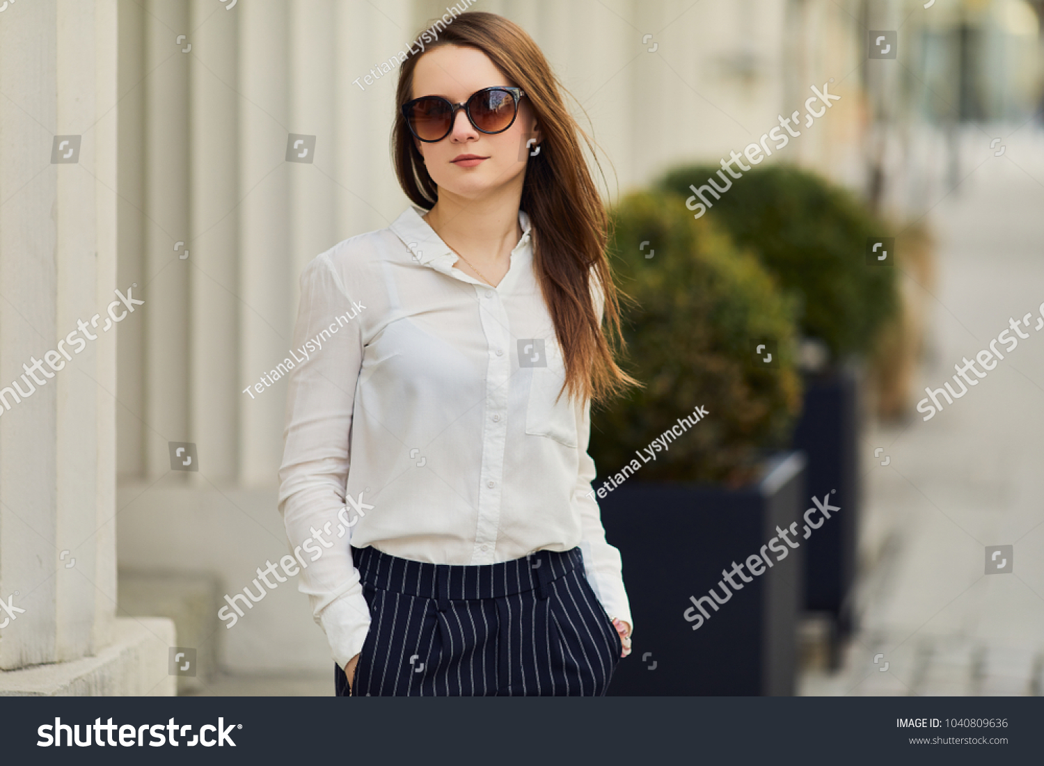 Young pretty woman walk on the street wear glasses and office clothing, spring time #1040809636