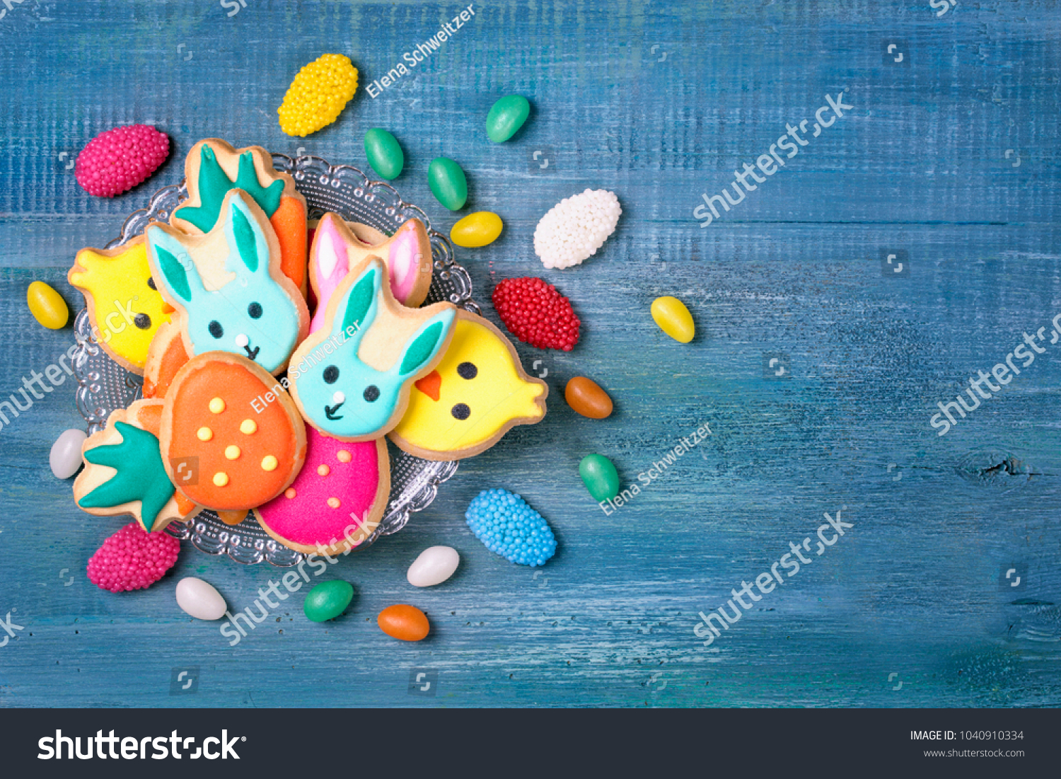 Colorful sweets on a blue wooden background #1040910334