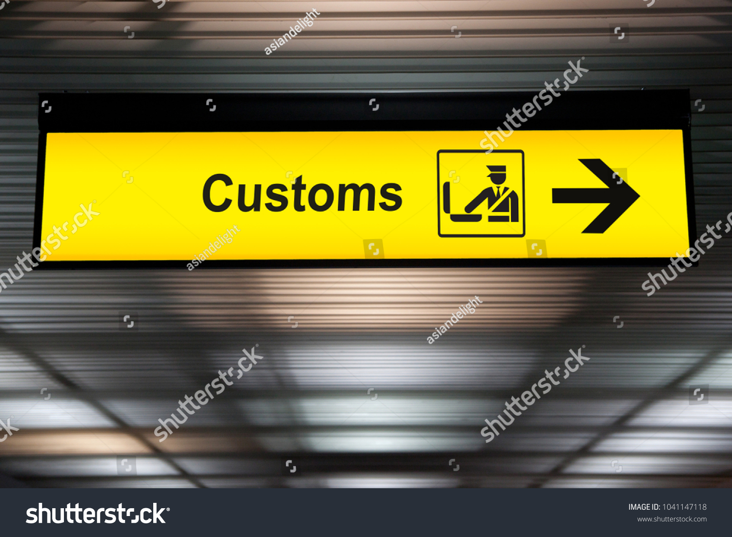 airport customs declare sign with icon and arrow hanging from airport ceiling at international terminal. customs declare for import and export concept #1041147118