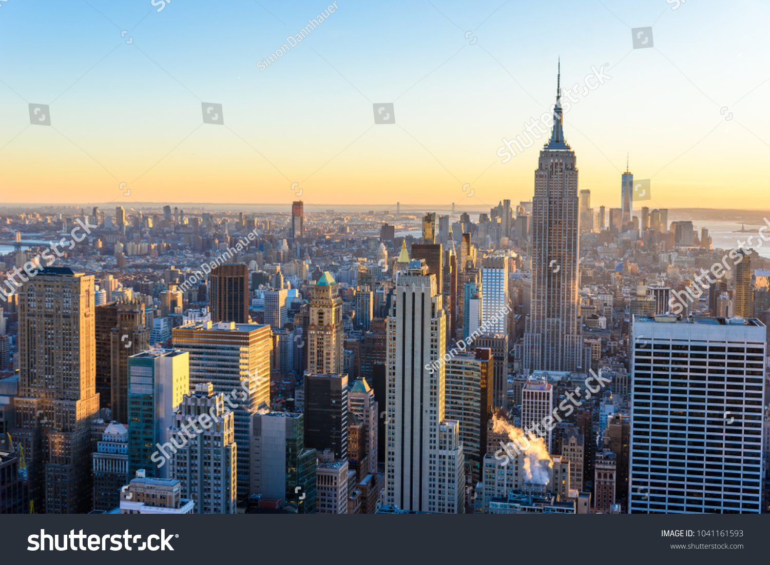 New York City - USA. View to Lower Manhattan downtown skyline with famous Empire State Building and skyscrapers at sunset. #1041161593