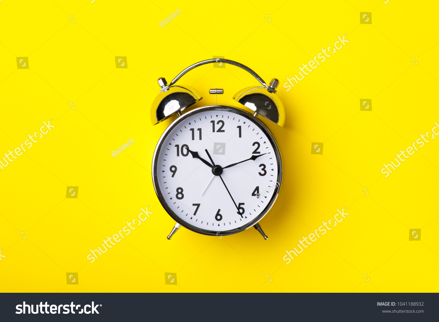 Retro alarm clock on bright yellow background #1041188932