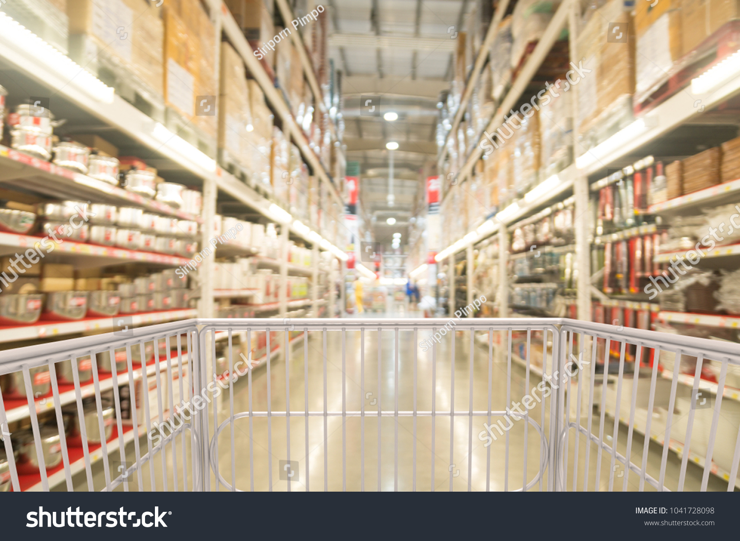 Trolley Shopping Cart Between Kitchenware Shelf Section in Supermarket  Warehouse Retail Outlet as Modern Lifestyle Shopping Concept with bokeh. #1041728098