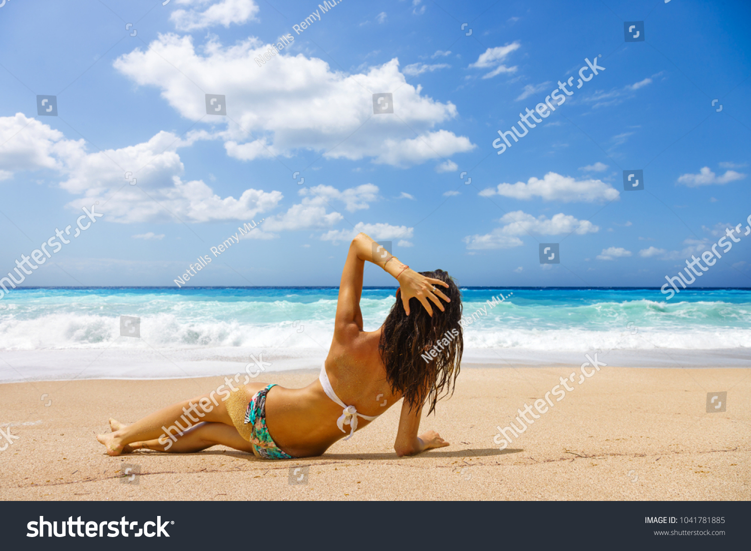 Woman suntanning at the beach #1041781885