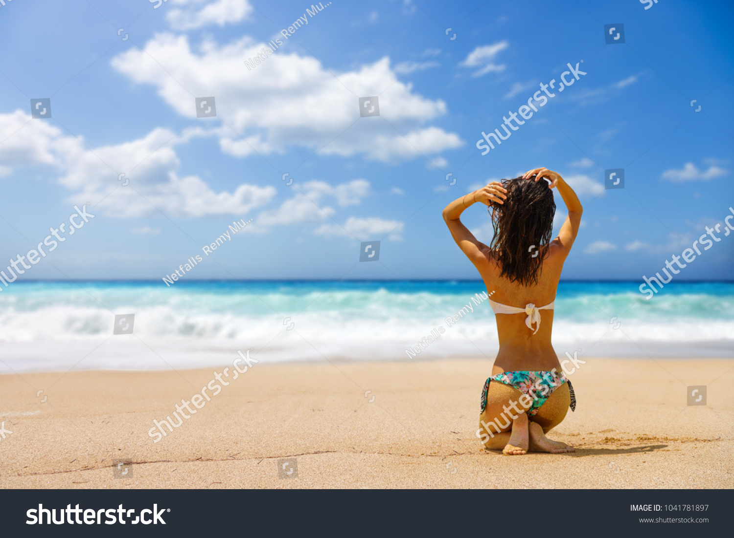 Woman suntanning at the beach #1041781897