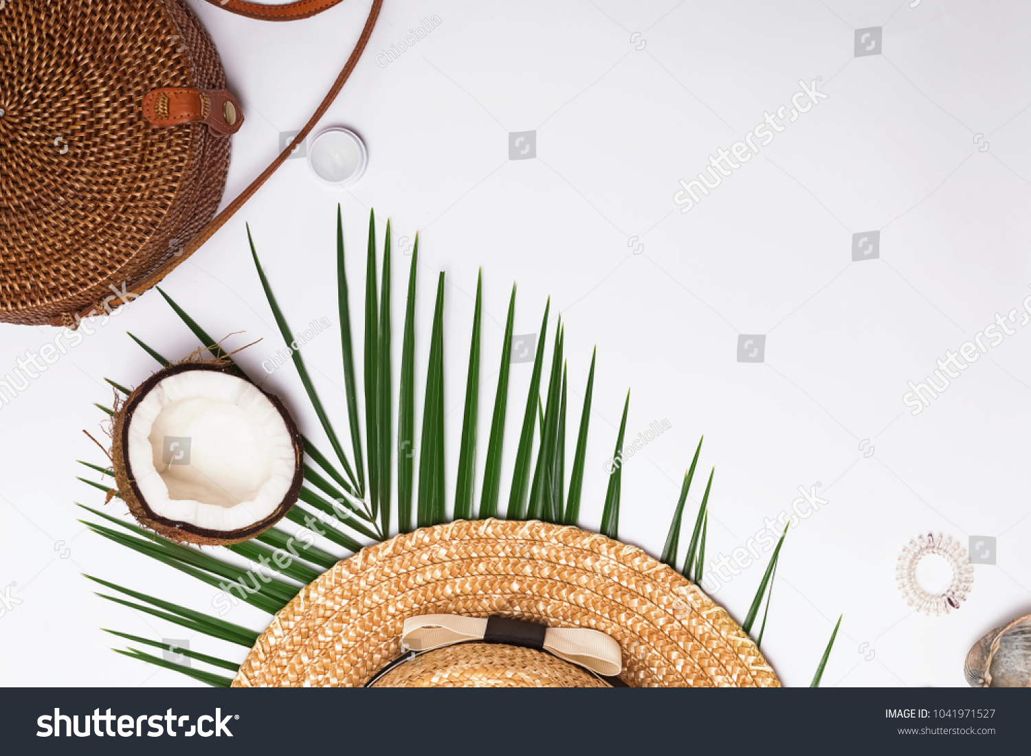 Feminine accessories, greem leaves and half of the coconut. Summer flat lay. #1041971527