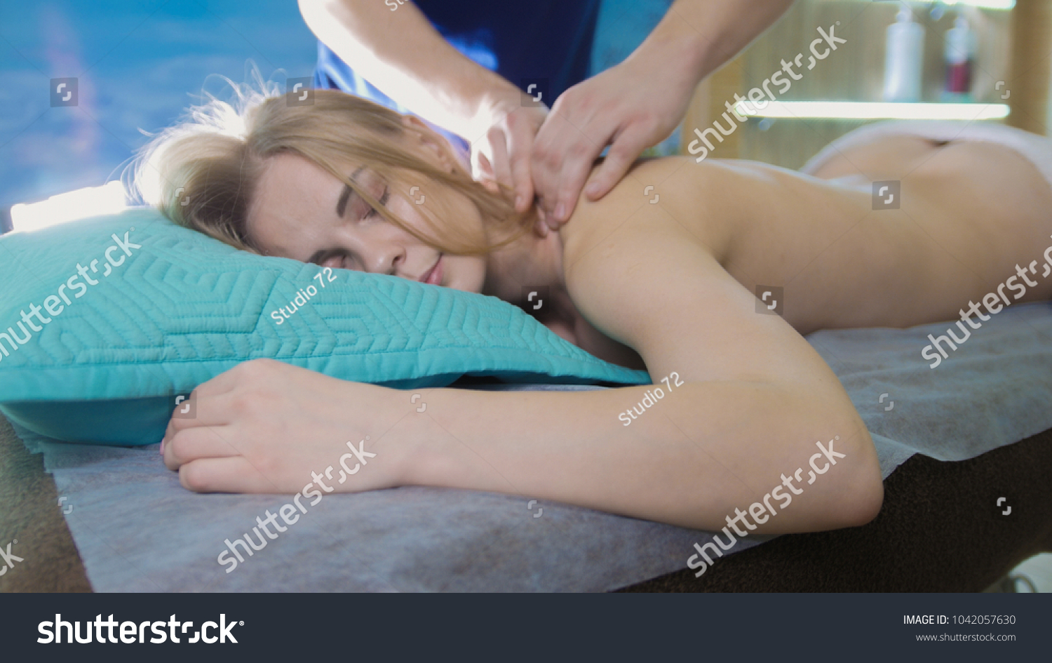 Massage parlor - young girl gets relaxing healing therapy for head #1042057630