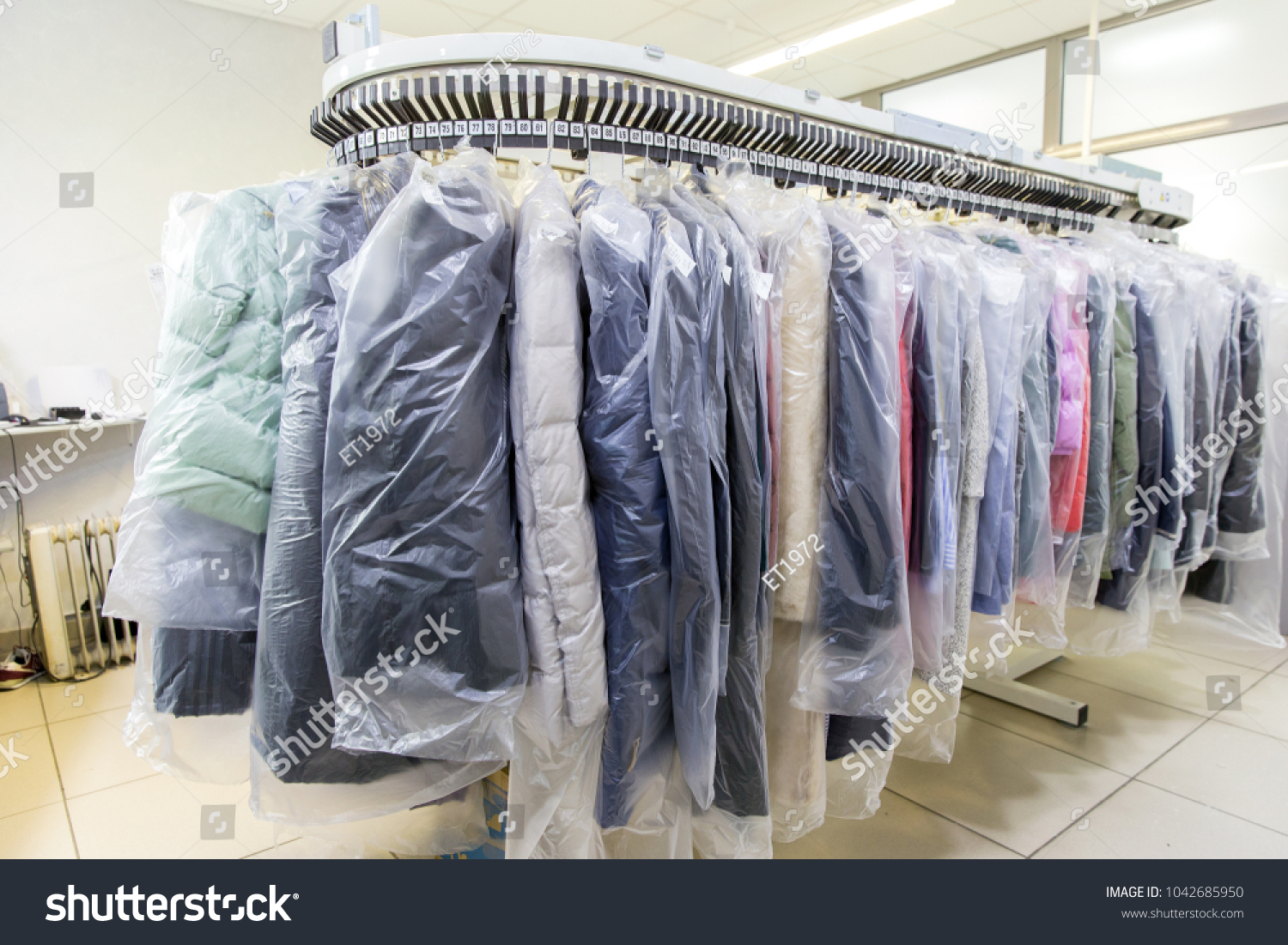 Clothes after dry cleaning in the laundry #1042685950