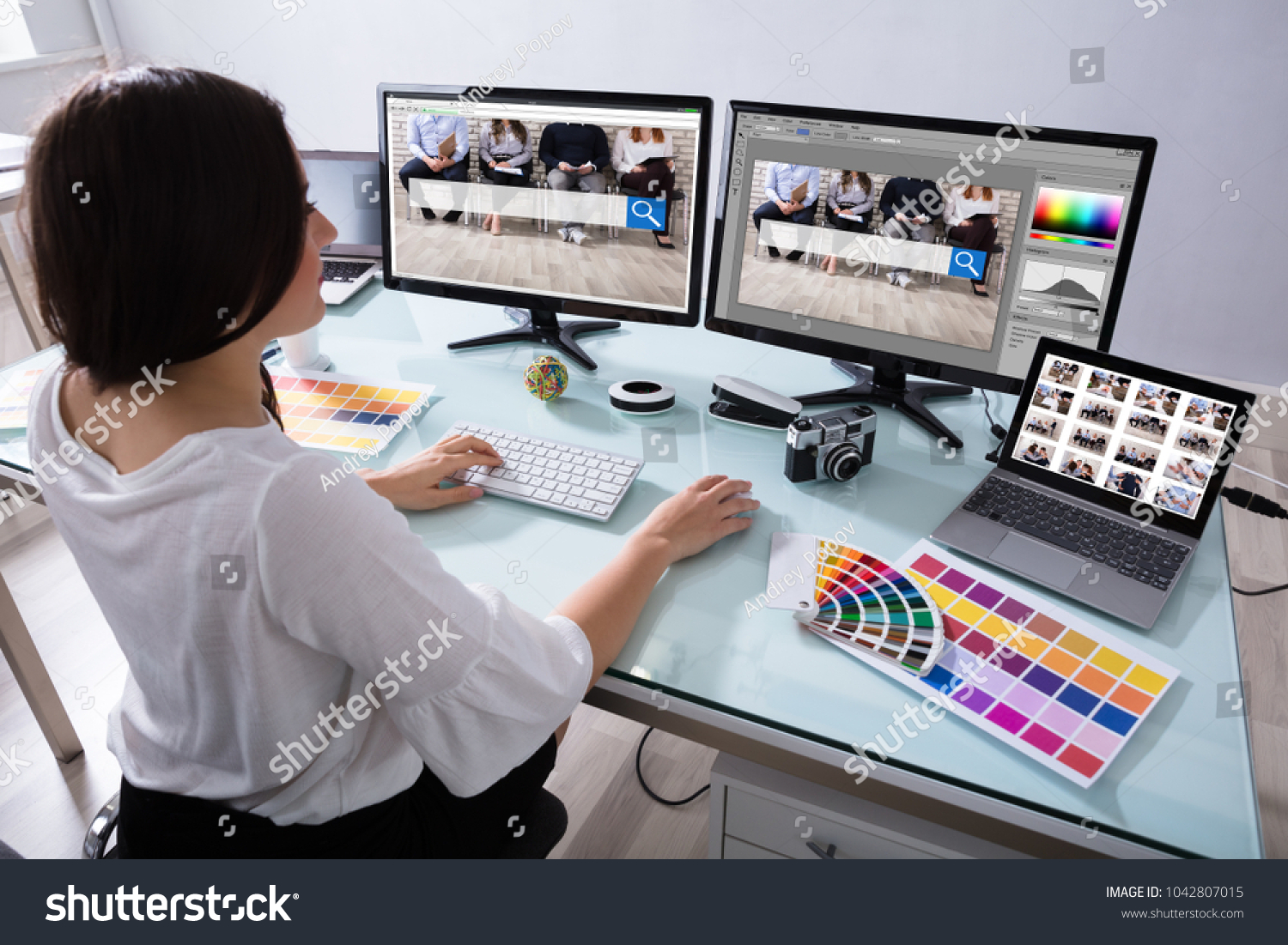 Close-up Of A Female Designer Working On Multiple Computer At Workplace #1042807015