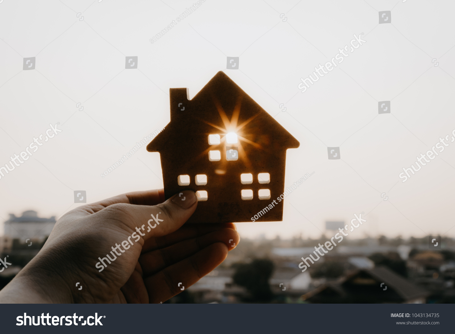 House model in home insurance broker agent ‘s hand or in salesman person. Real estate agent offer house, property insurance and security, affordable housing concepts #1043134735