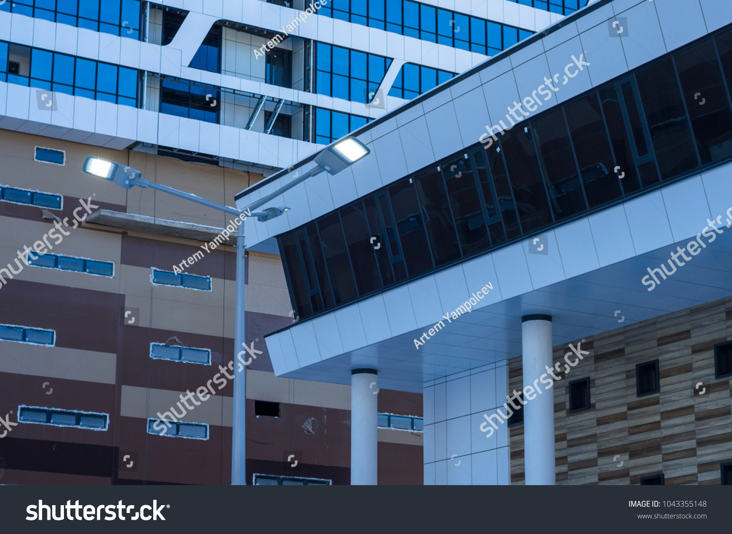 Facing the building with a ventilated facade. Aluminum colored facades. Modern facades of high-rise buildings. Construction of a large residential complex. #1043355148