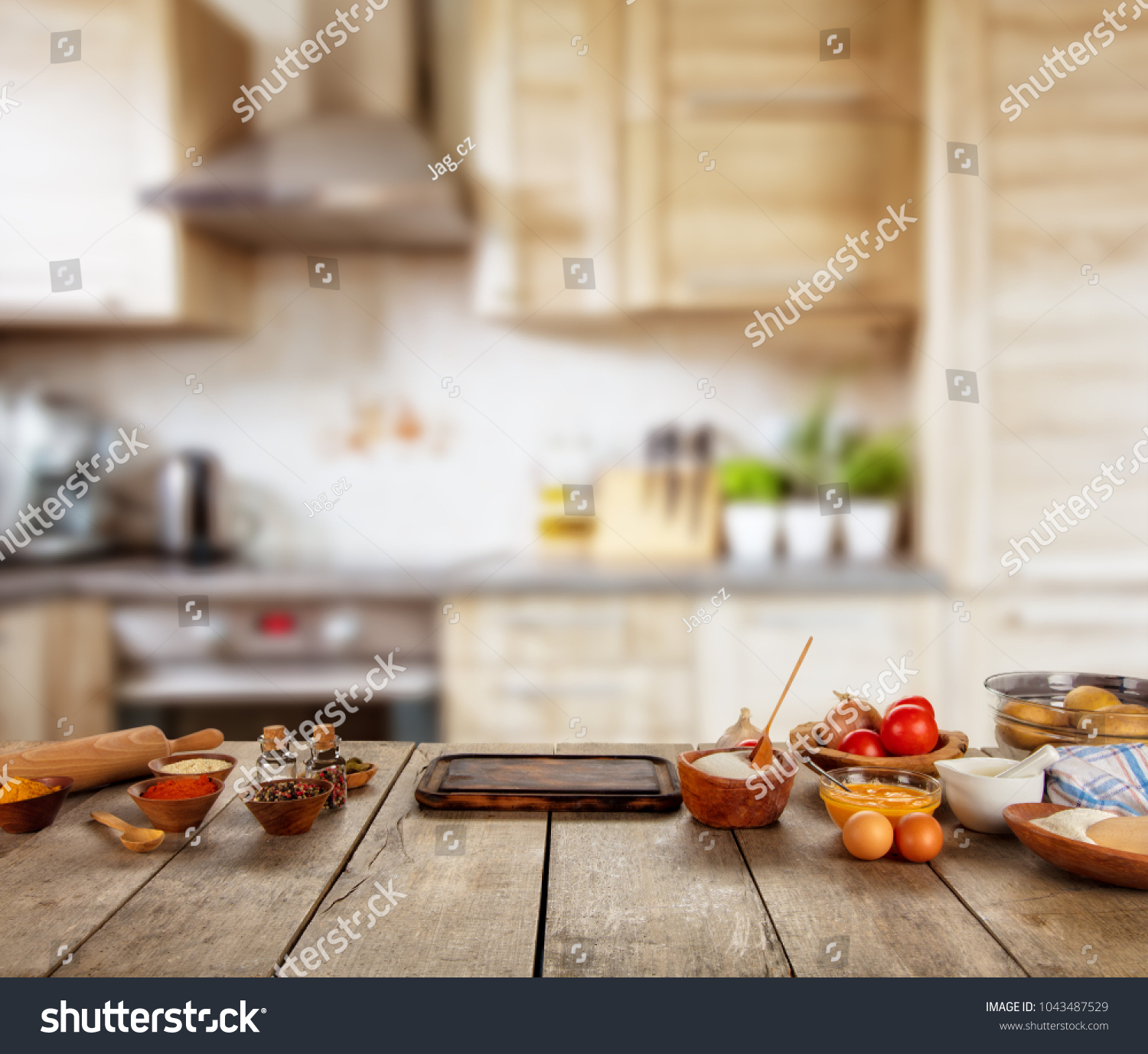 Baking ingredients placed on wooden table, ready for cooking. Copyspace for text. Concept of food preparation, kitchen on background. #1043487529
