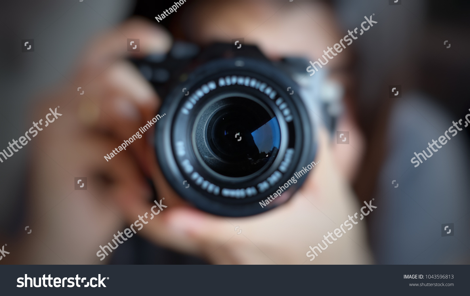 Soft focus of women photographer hold camera and taking a photo.  #1043596813