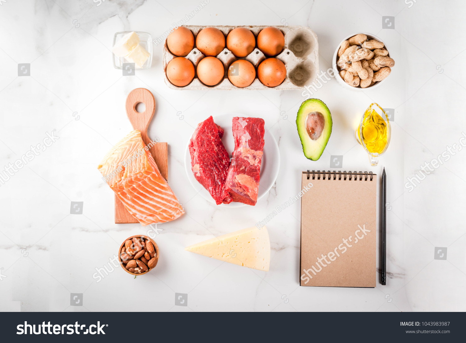Ketogenic low carbs diet concept. Healthy balanced food with high content of healthy fats. Diet for the heart and blood vessels. Organic ingredients, white background, copy space top view, notepad  #1043983987