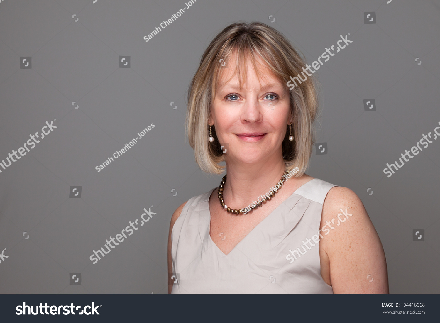 Head Shot Portrait of Attractive Smiling Elegant Woman on Grey Background #104418068