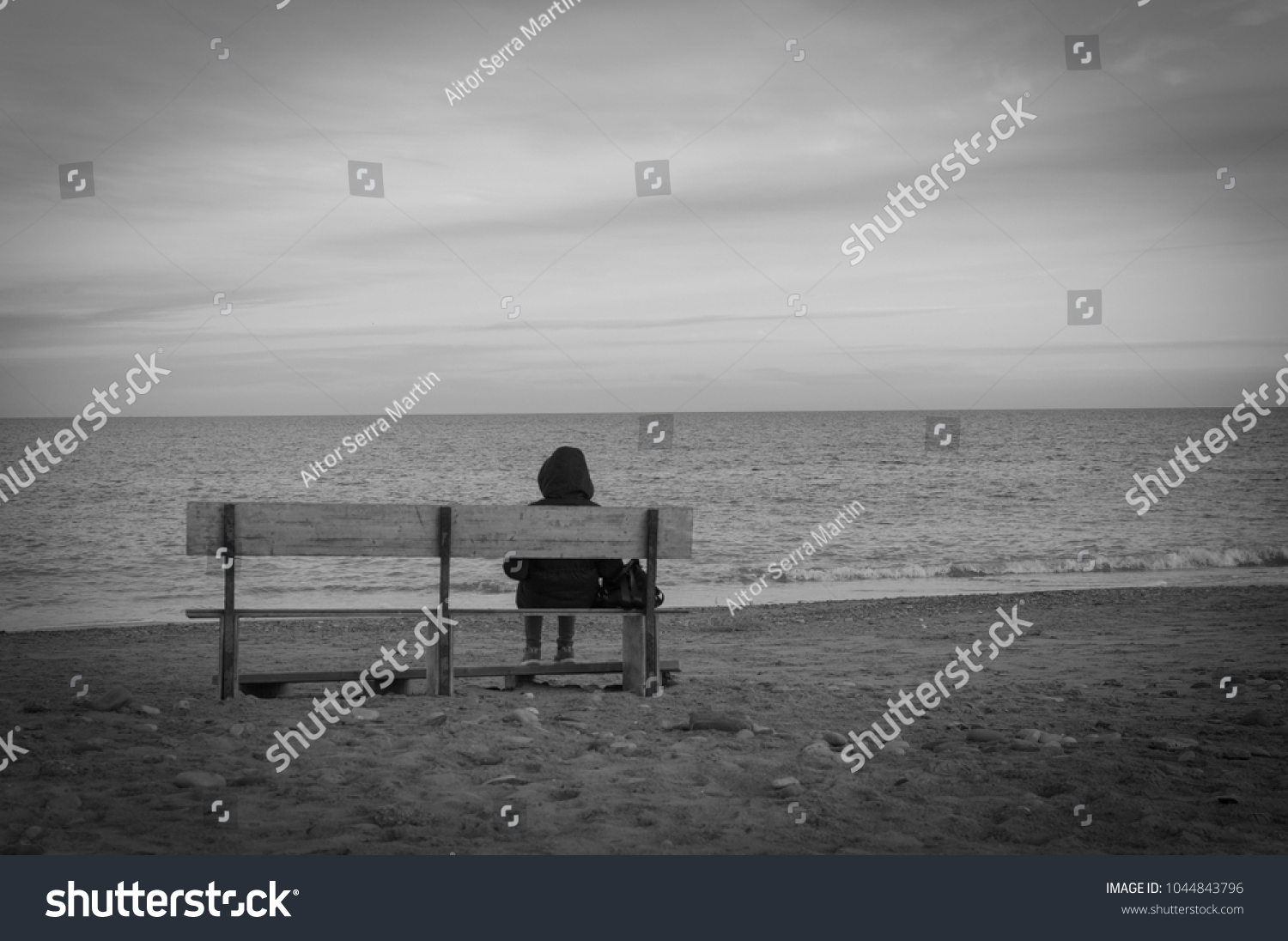 depressed and sad woman facing the sea #1044843796