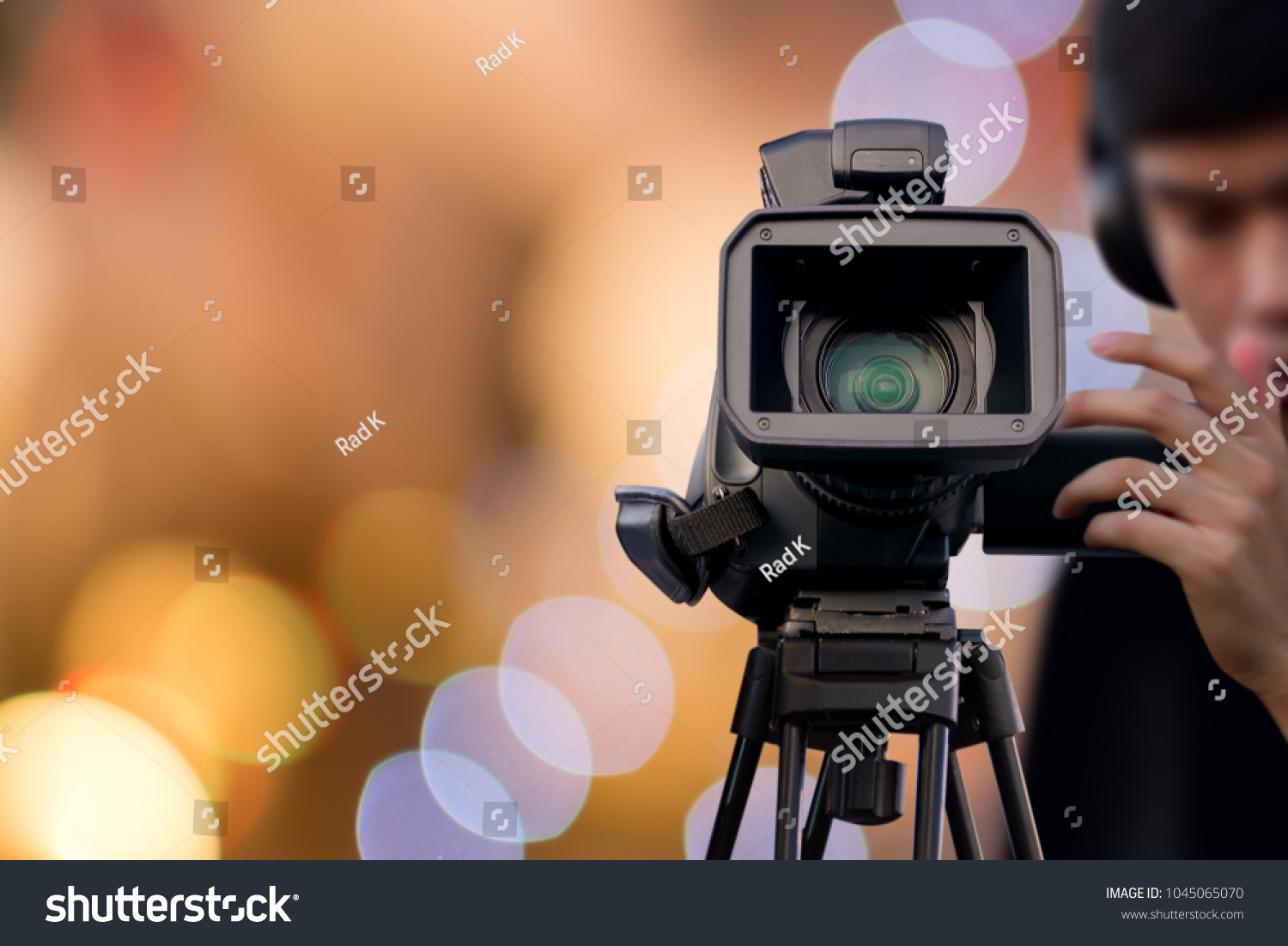 Camera Operator recording event with video camera #1045065070