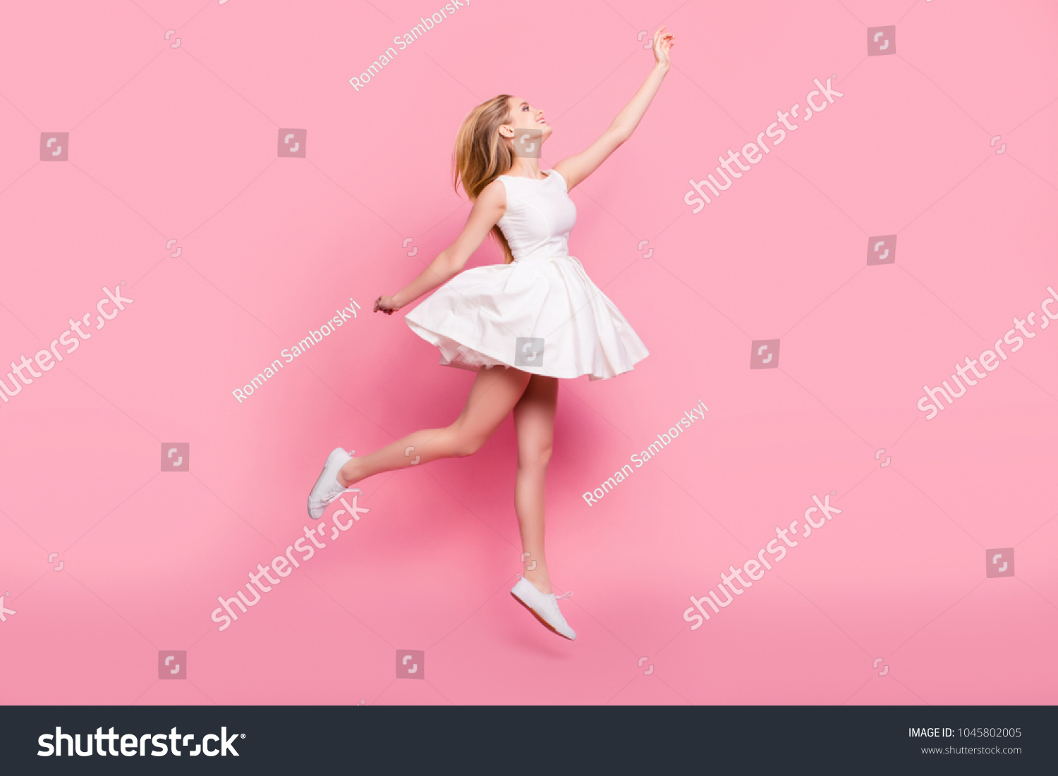 Full-size full-length side view portrait of beautiful attractive carefree tender gentle innocent stylish excited cheerful girl jumping up wants to touch sky isolated on background copy-space #1045802005