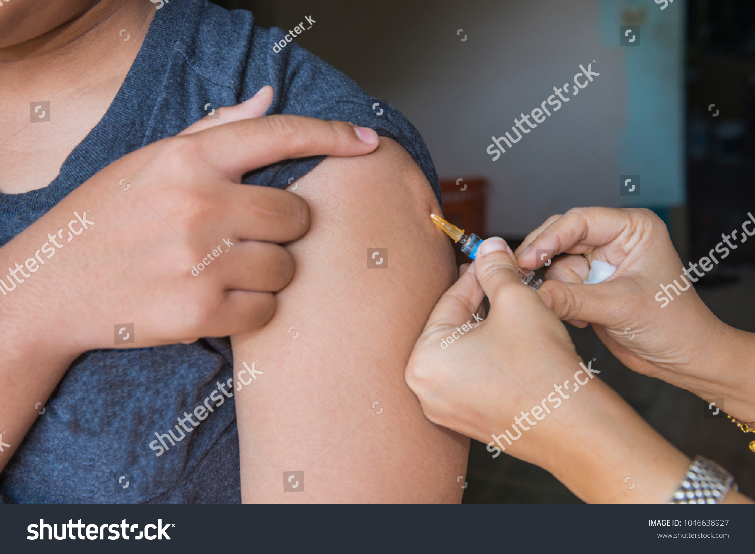 Nurse are vaccinations to patients using the syringe.Doctor vaccinating women in hospital.Are treated by the use of sterile injectable upper arm. Close up injection,antibody,influenza vaccine #1046638927