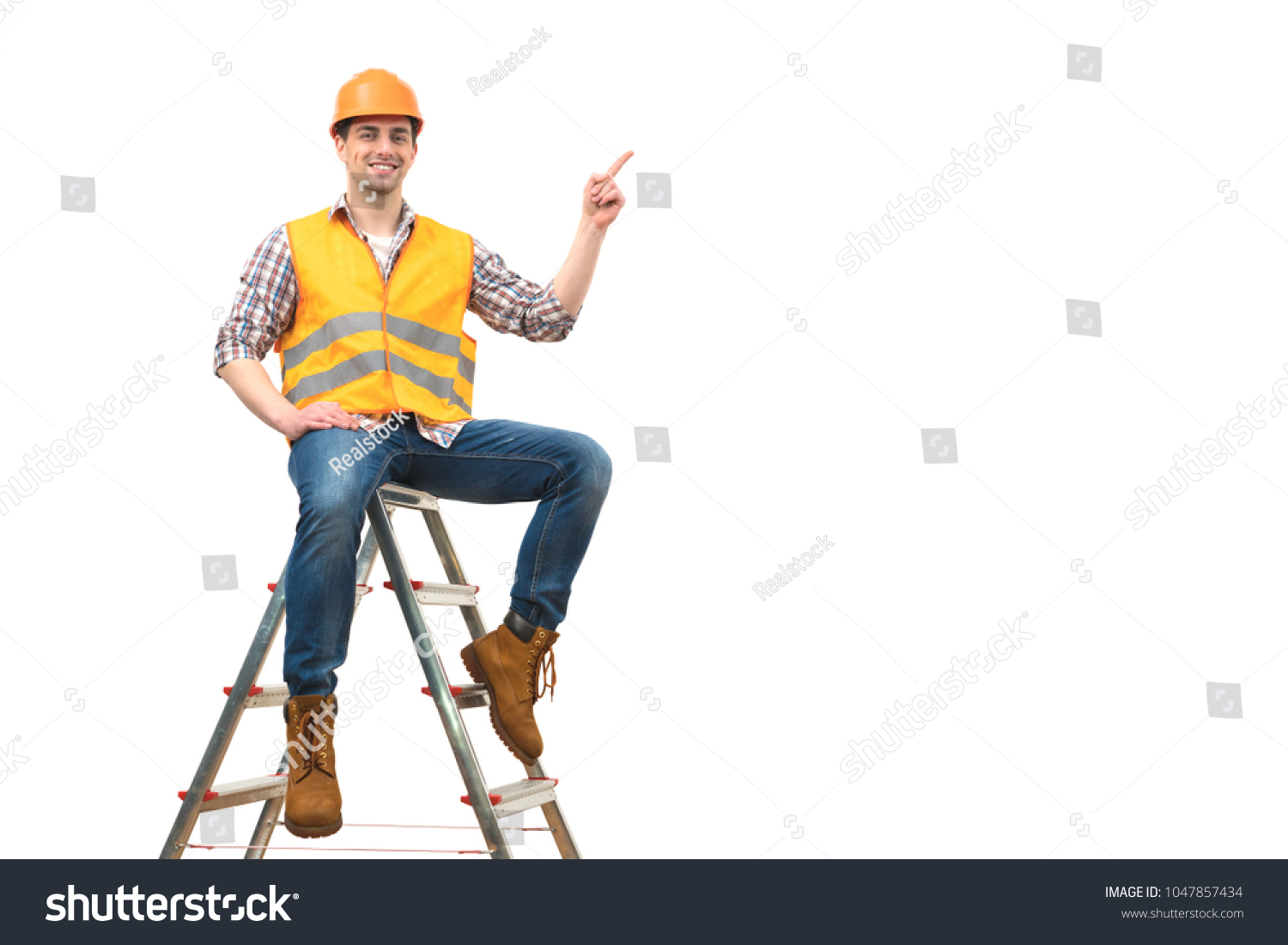 The happy builder on the ladder gesturing on the white background #1047857434