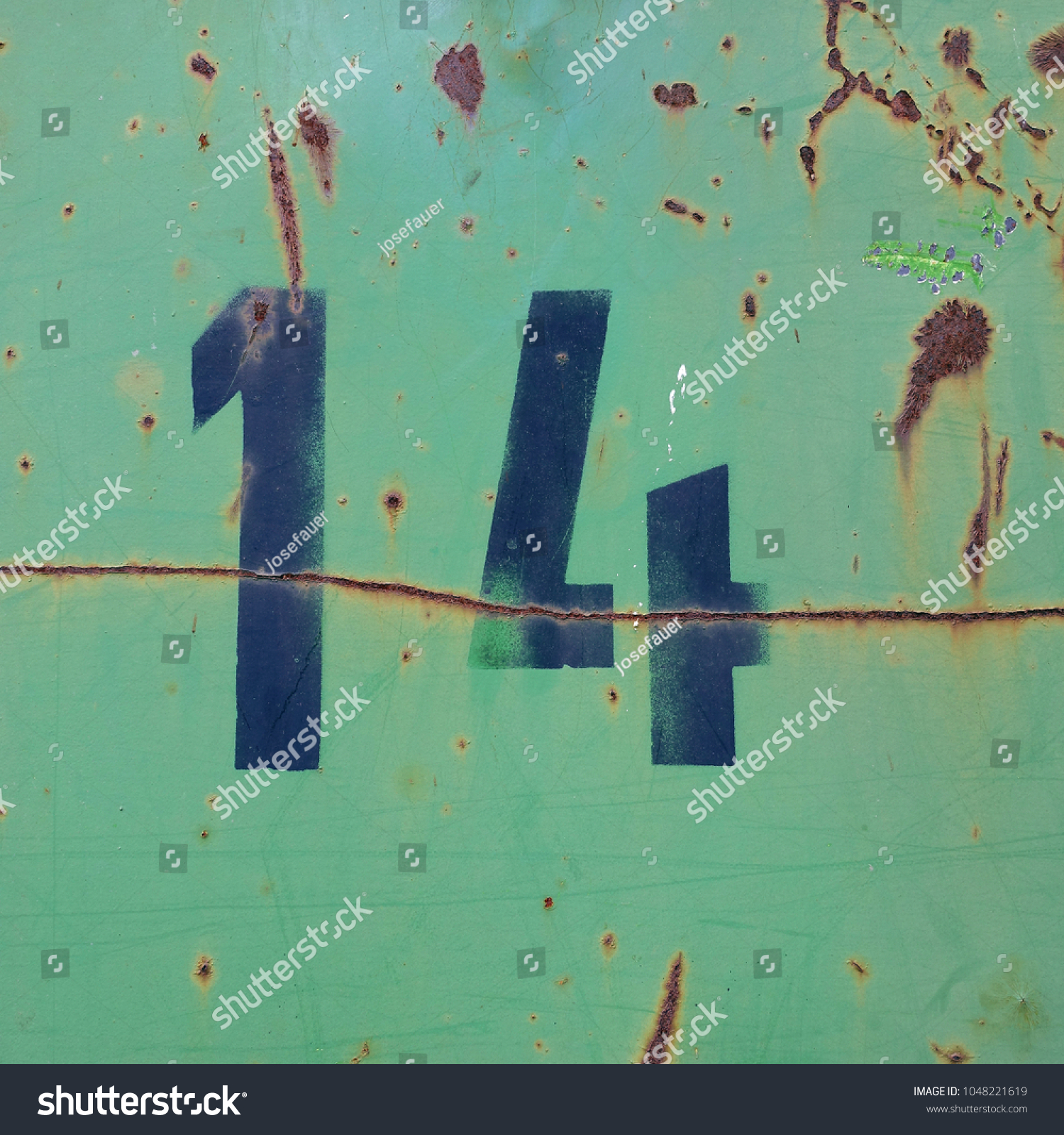 number fourteen, black stencil letters on rusty green metal background #1048221619