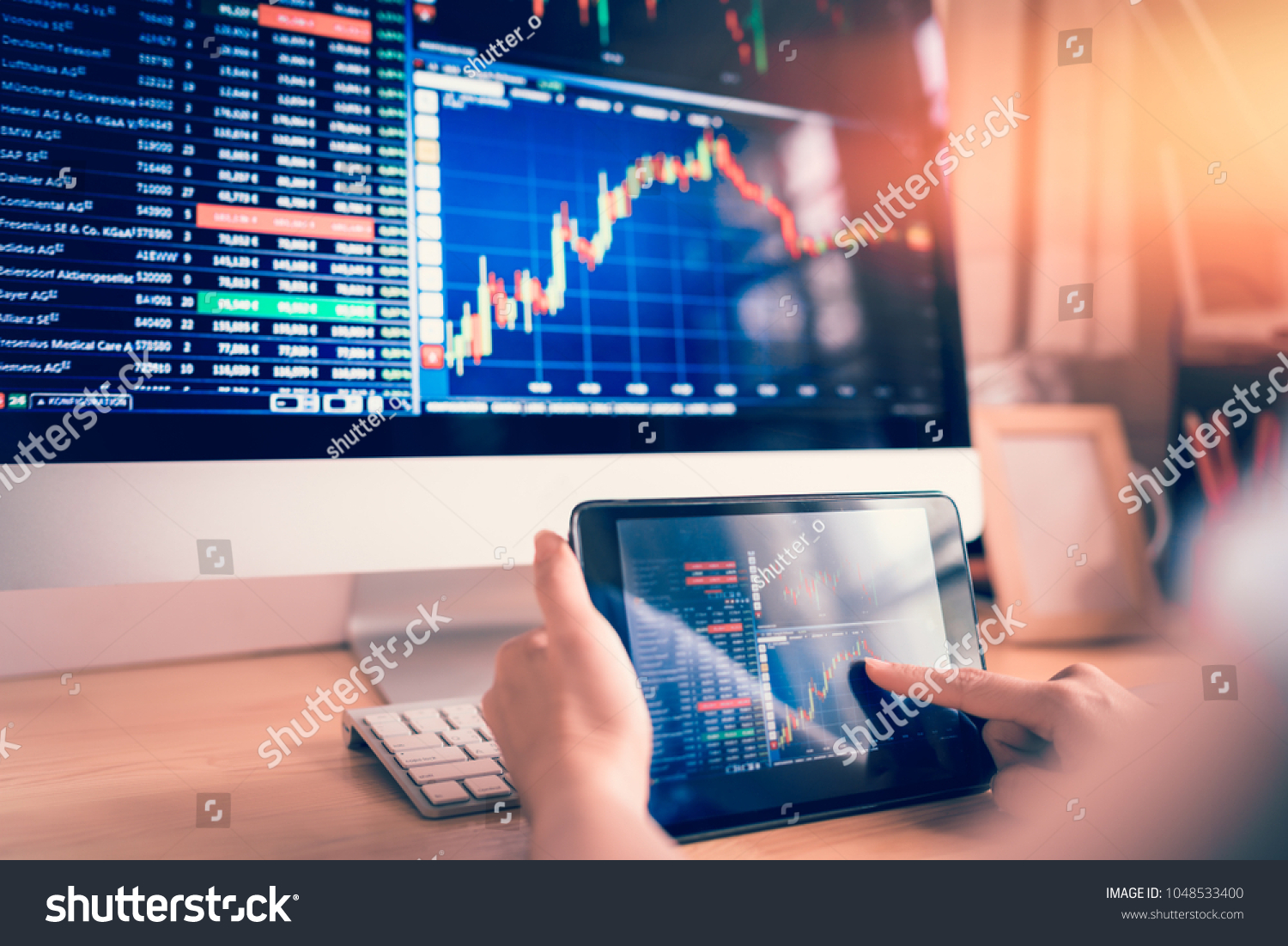 Businesswoman trading stocks with tablet and graph Analysis in desktop computer #1048533400