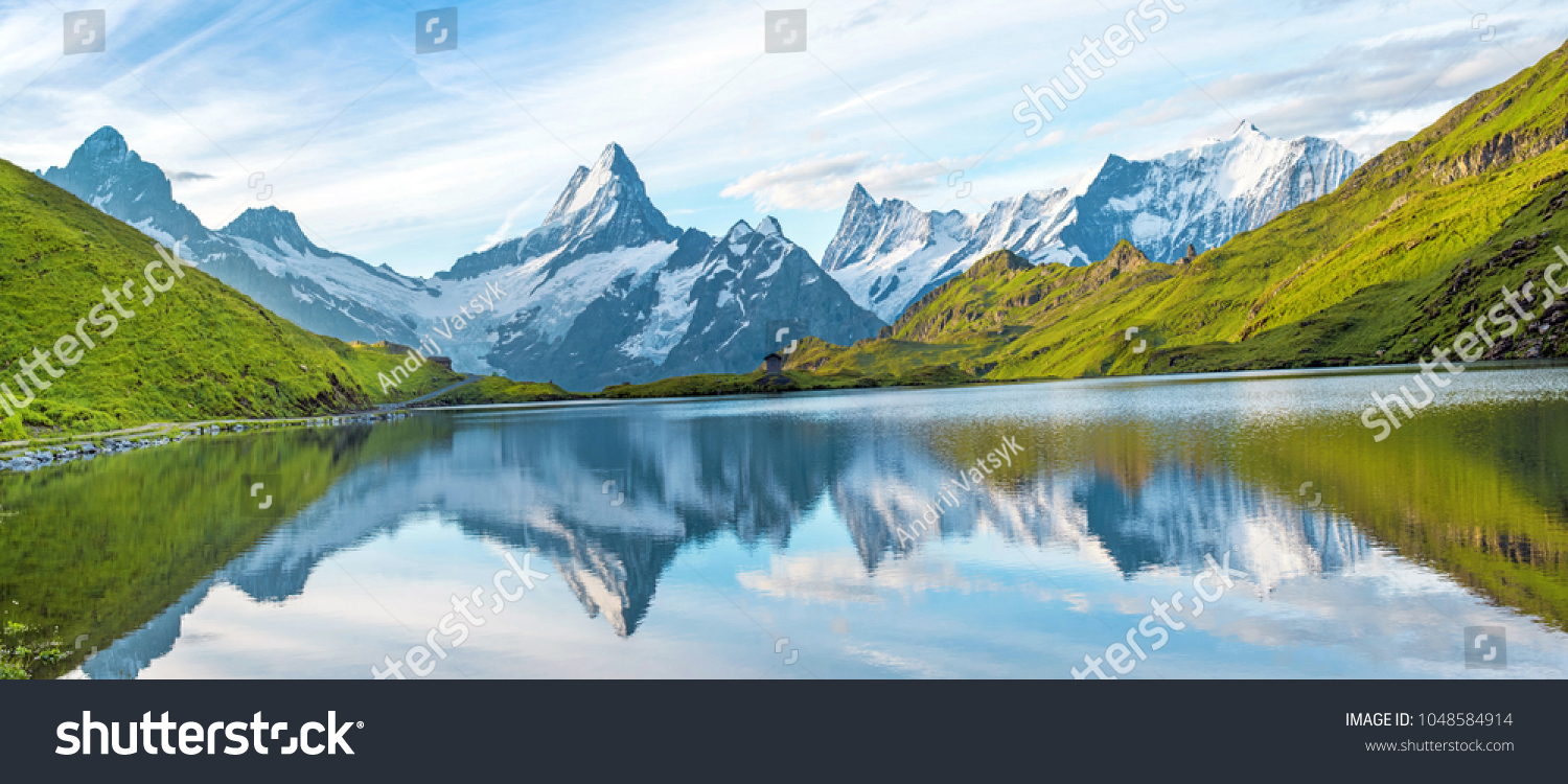 A magical panorama landscape with a lake in the mountains in the Swiss Alps, Europe. Wetterhorn, Schreckhorn, Finsteraarhorn et Bachsee. ( relaxation, harmony, anti-stress - concept).  #1048584914