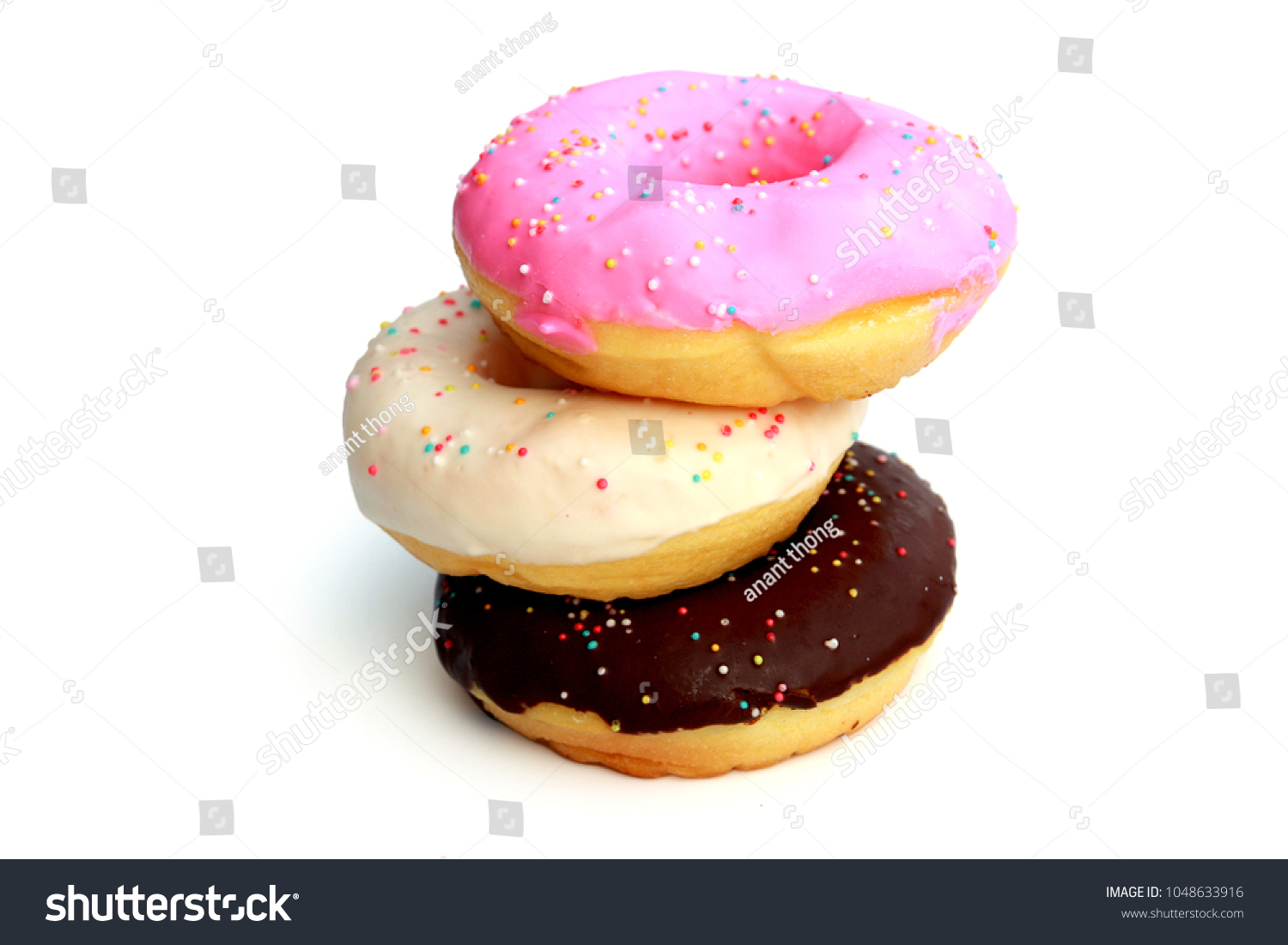 Three donuts are pink, white, Chocolate  with sprinkles isolated on white background #1048633916