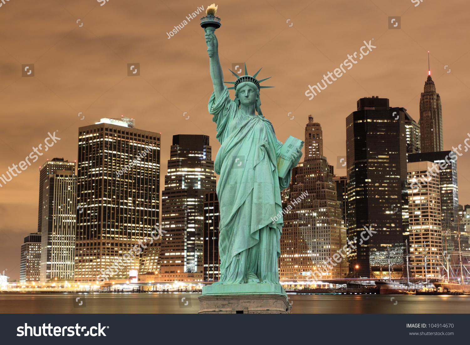 Manhattan Skyline and The Statue of Liberty at Night, New York City #104914670
