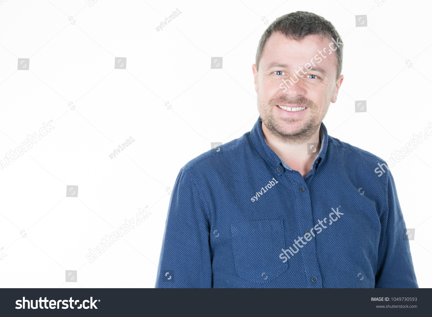 Portrait of smiling man with hands in pockets, isolated on white background #1049730593