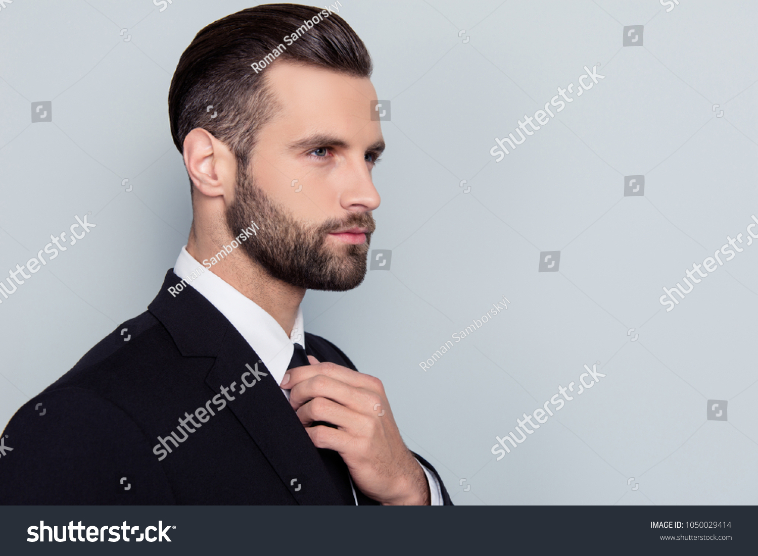 Half-faced portrait of stylish trendy handsome stunning attractive serious concentrated smart clever intelligent with modern haircut hairdo isolated on gray background copy-space #1050029414