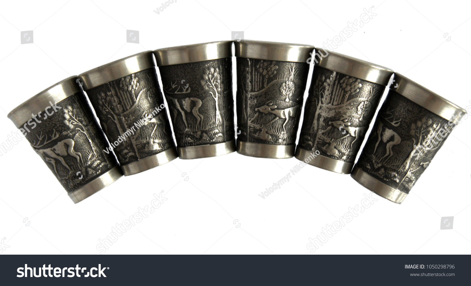 Pewter wine goblets or shot glasses with relief isolated on a white background #1050298796