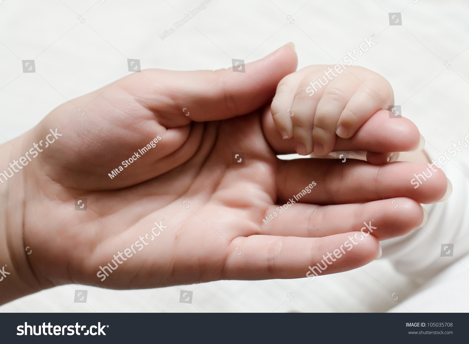 Newborn baby holding mother hand. #105035708