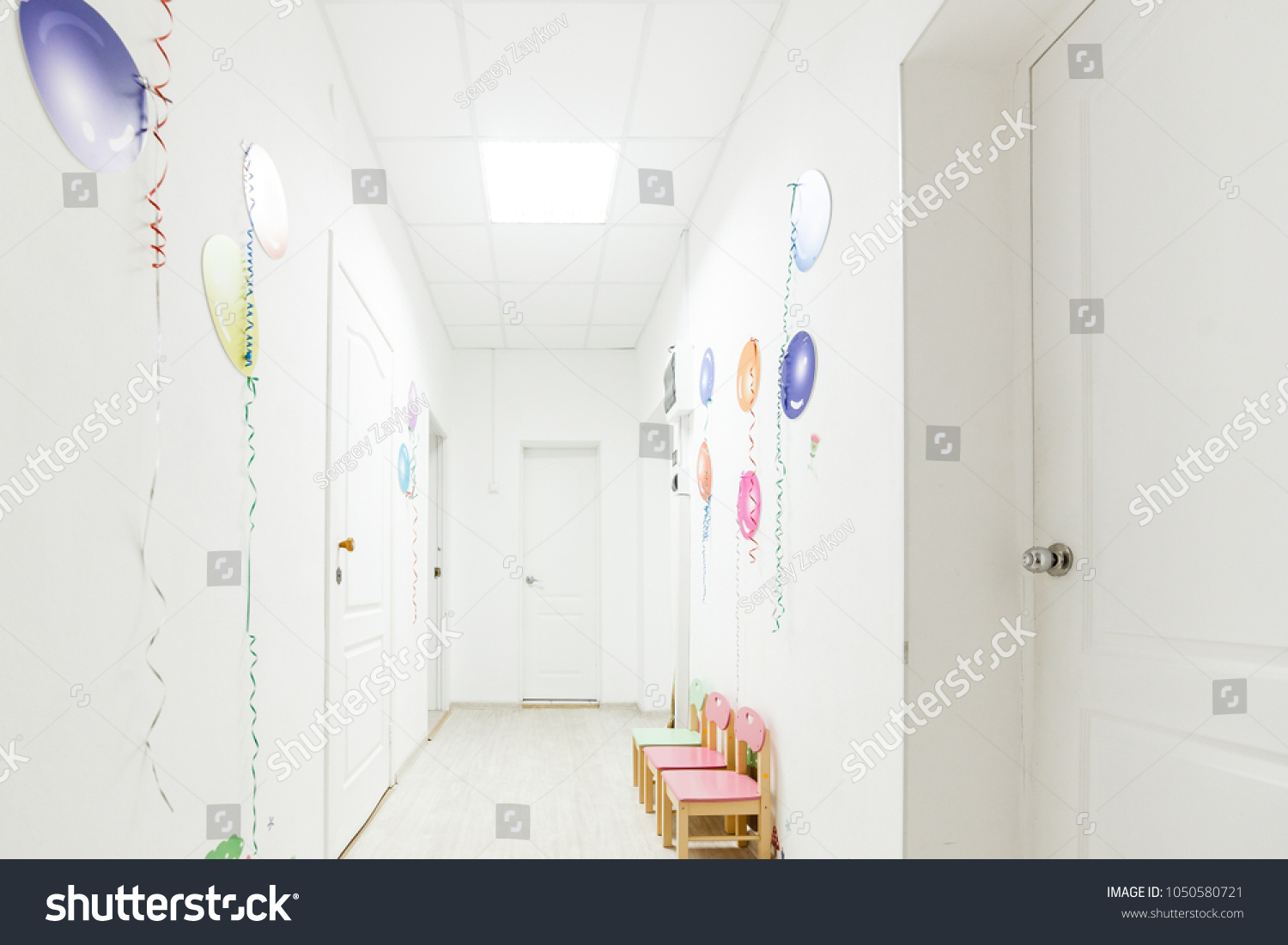 Bright interior of corridor hallway of a nursery school during the holidays without children #1050580721