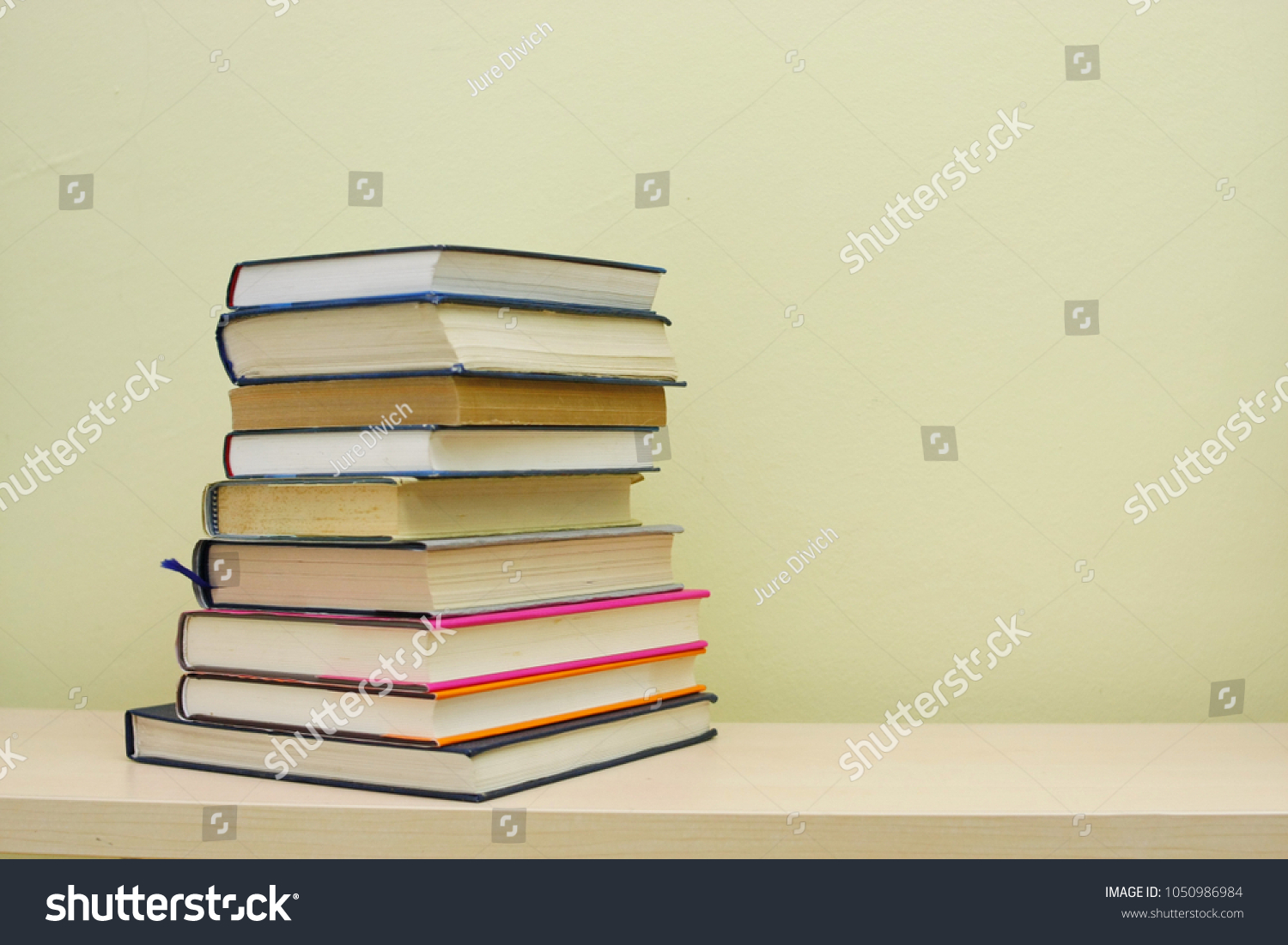 Stack of books on shelf #1050986984