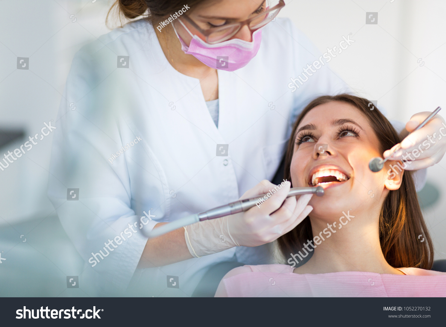 Dentist and patient in dentist office #1052270132