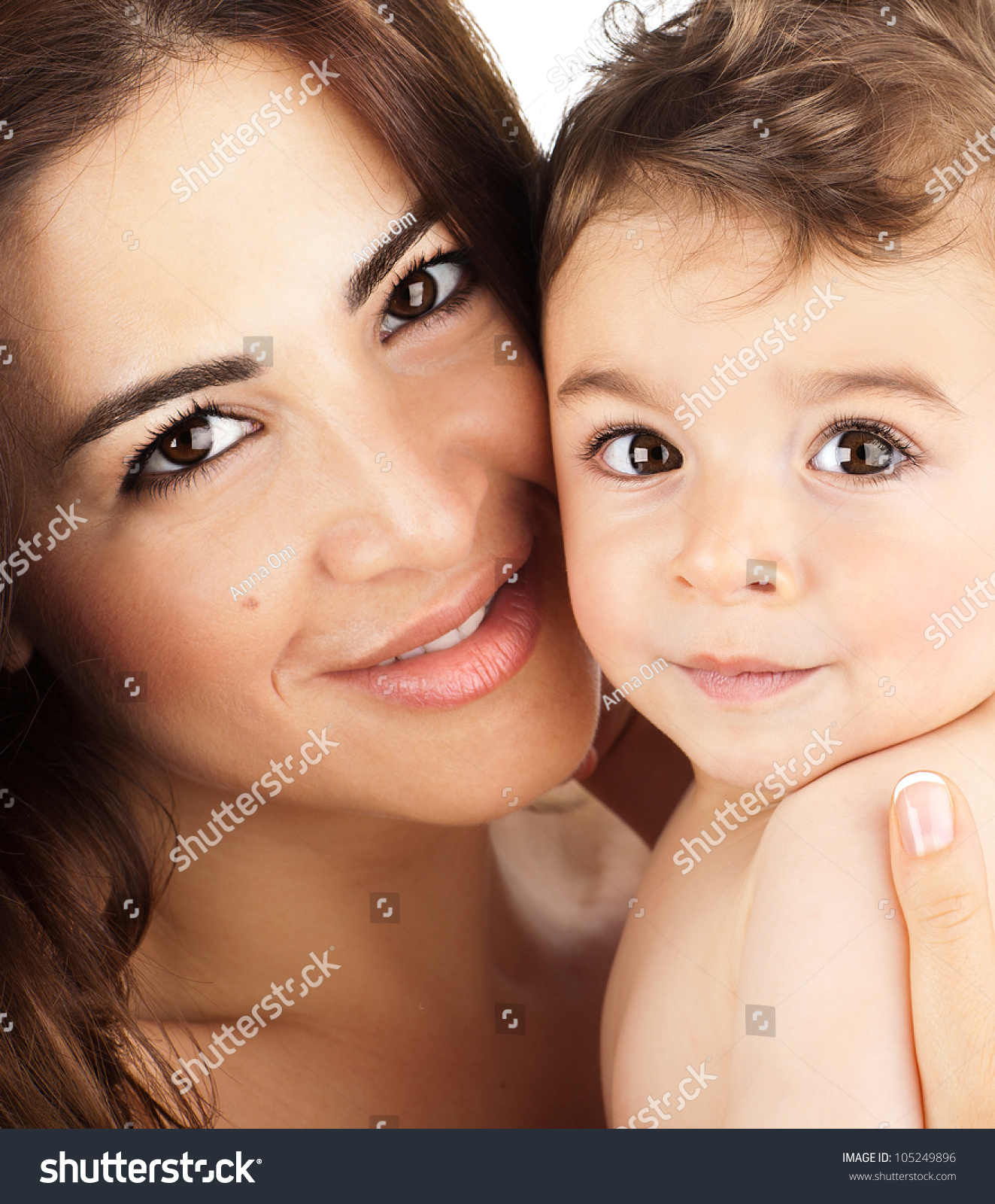 Mother and baby closeup portrait, happy faces, Arabic family picture, adorable small boy, mom and kid having fun indoor, parents joy, holding little child, healthy toddler and mommy, happiness concept #105249896