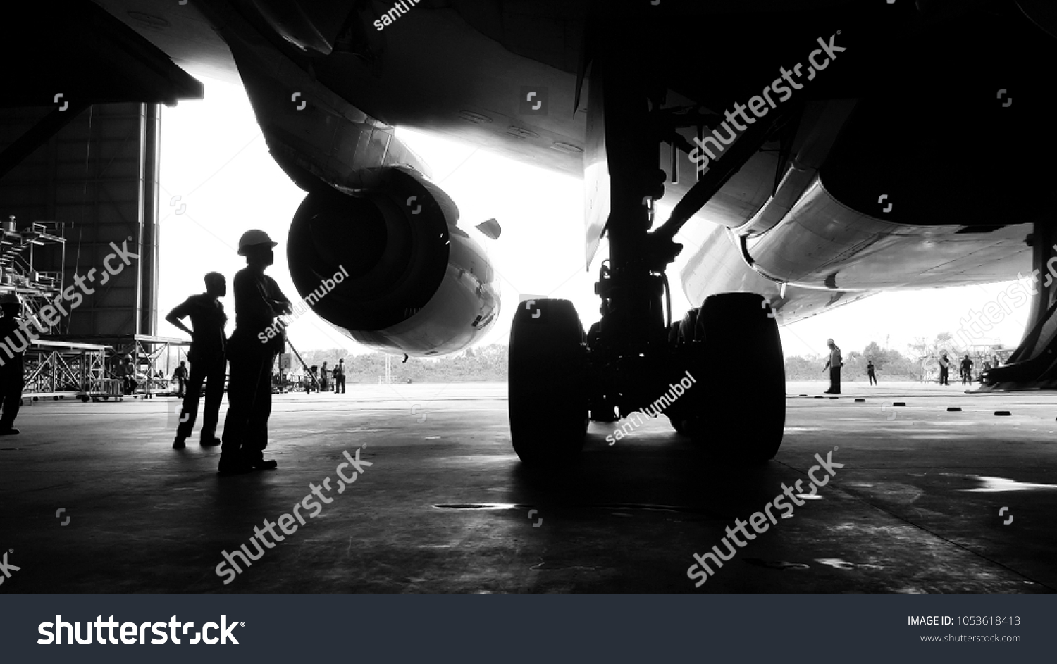 Aircraft push back into the  maintenance area.Aircraft(airplane)in aircraft hangar for maintenance service check by aircraft technician.Maintenance before flight. #1053618413