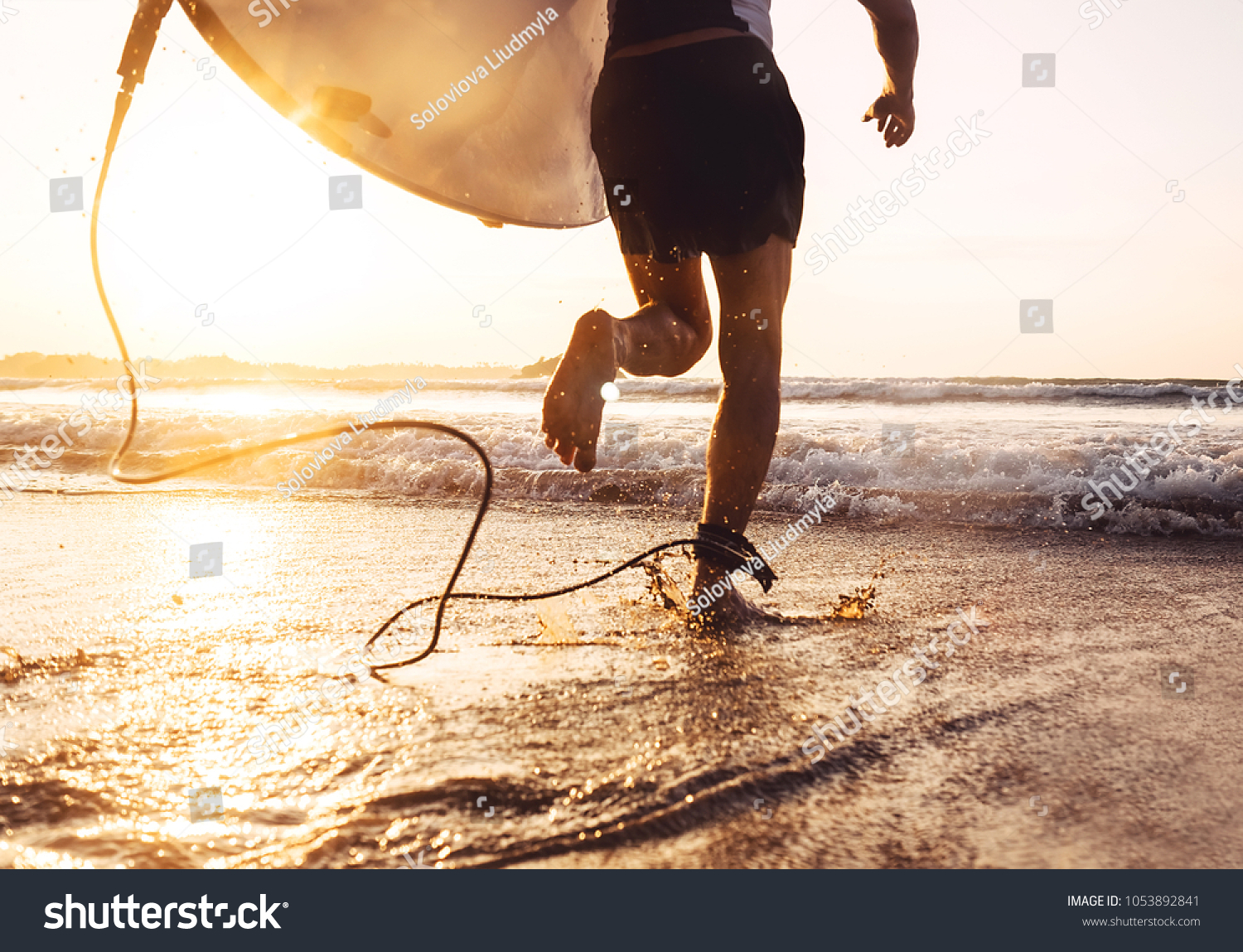 Man surfer run in ocean with surfboard. Active vacation, health lifestyle and sport concept image #1053892841