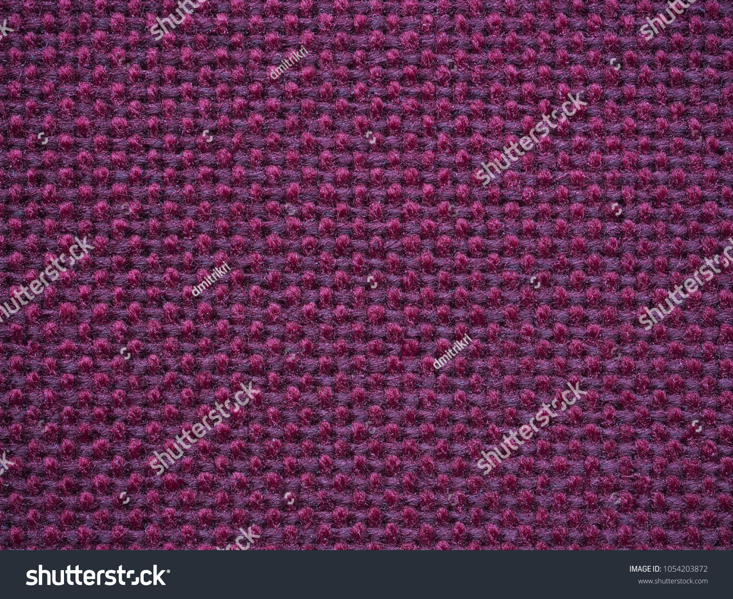 Close-up of the purple textile texture, background and wallpaper. The texture of purple fabric textile upholstery of furniture. High-quality macro photography. #1054203872