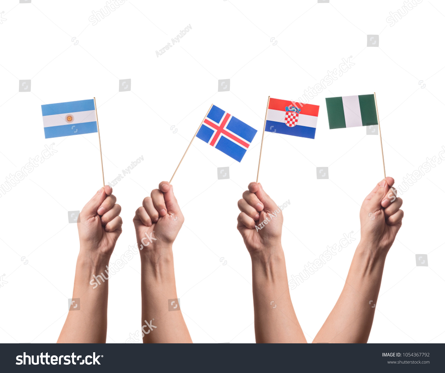 Little paper national flags in hands isolated on white background. Flags of national football teams of Argentina, Iceland, Croatia, Nigeria. World cup competitors in group D #1054367792