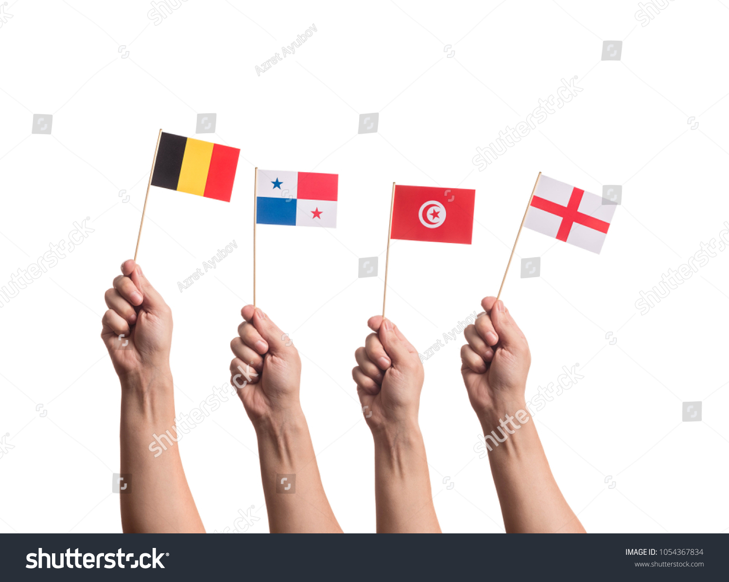 Little paper national flags in hands isolated on white background. Flags of national football teams of Belgium, Panama, Tunisia, England. World cup competitors in group G #1054367834
