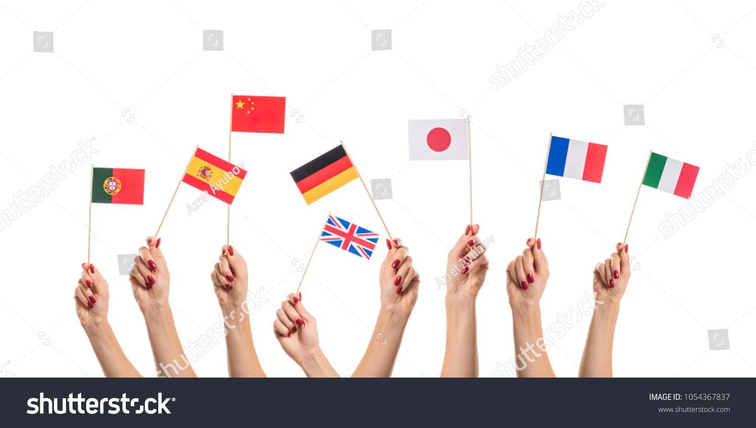National flags of Germany, England, Italia, Japan, China Spain, France, Portugal in hands. Language studying concept on white background #1054367837