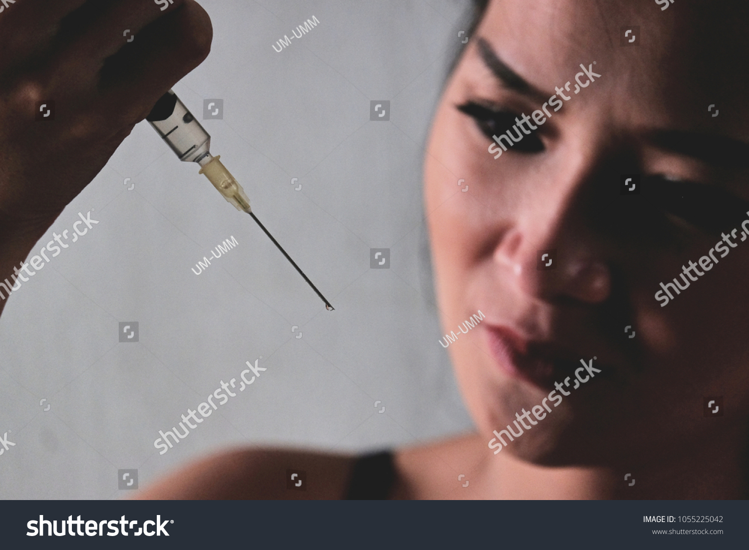Woman with drug addiction, addict lady with syringe using drug #1055225042