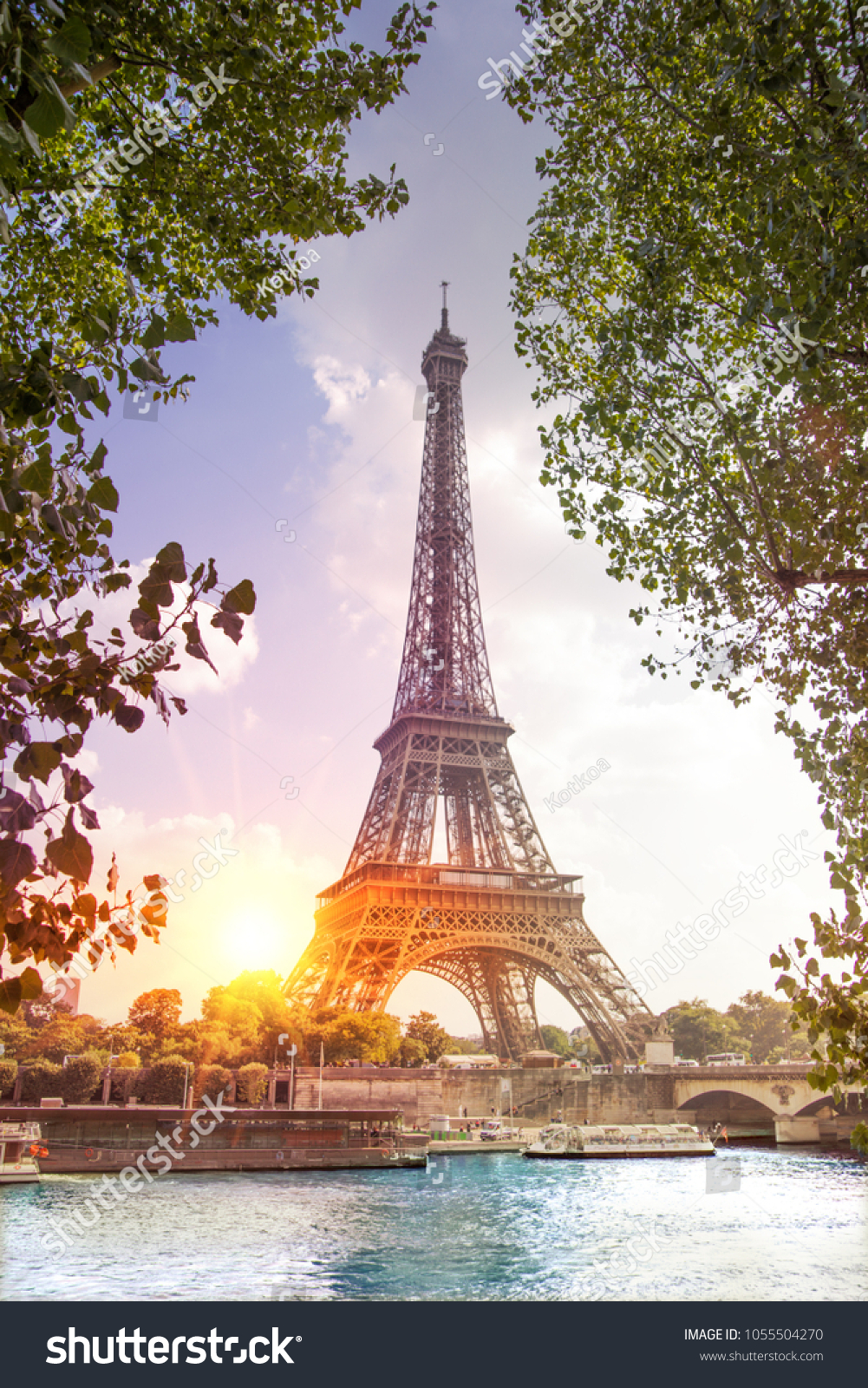 Romantic sunset background. Eiffel Tower with boats on Seine river in Paris, France. #1055504270