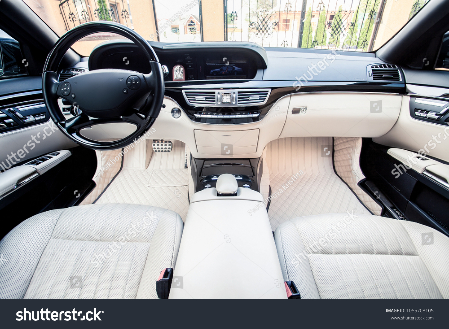 Luxury car interior. Steering wheel, shift lever and dashboard. #1055708105