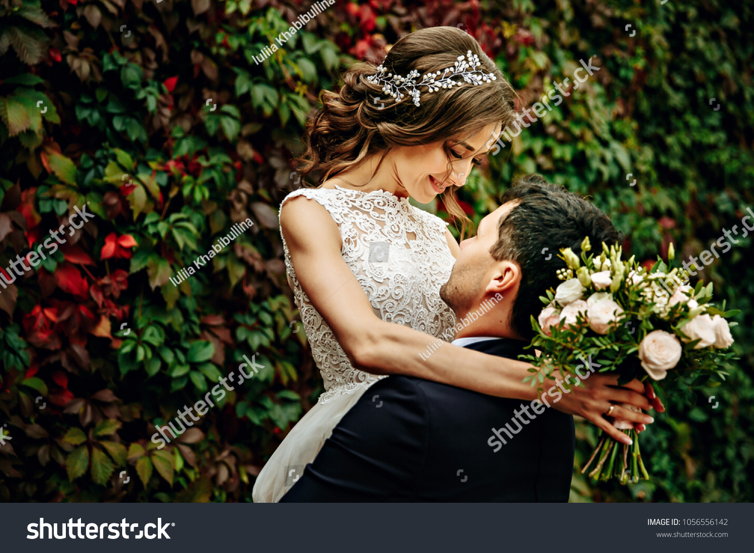 Happy young bride and groom on their wedding day. Wedding couple - new family! wedding dress. Bridal wedding bouquet of flowers #1056556142