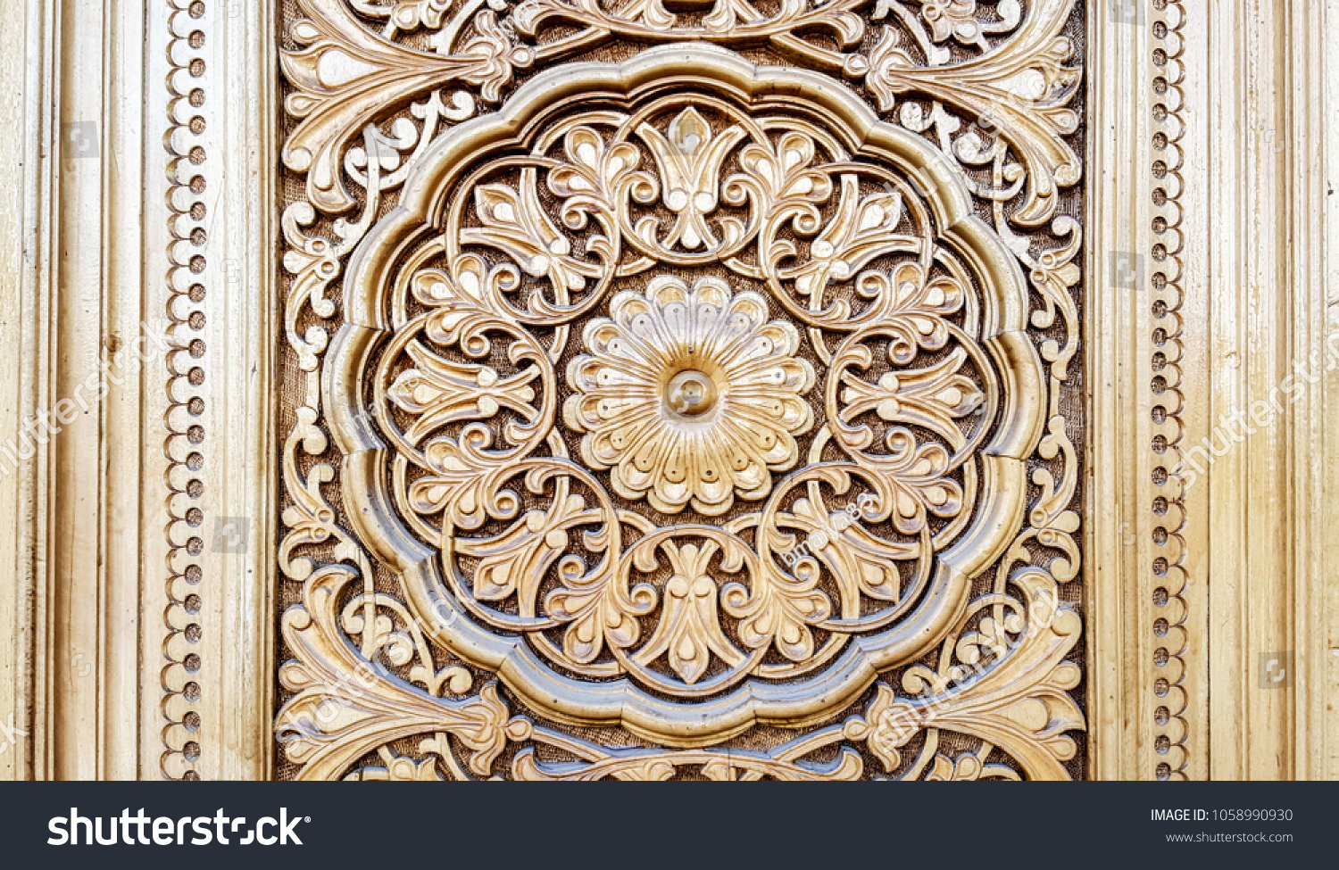 amazingly beautiful traditional Uzbek floral ornament carved on the wooden door of the mosque #1058990930
