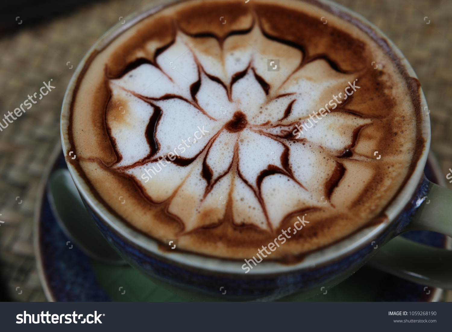 Closed up Hot coffee Latte beautiful  flower art in ceramic mug vintage good design morning beverage aroma on wooden table background  #1059268190