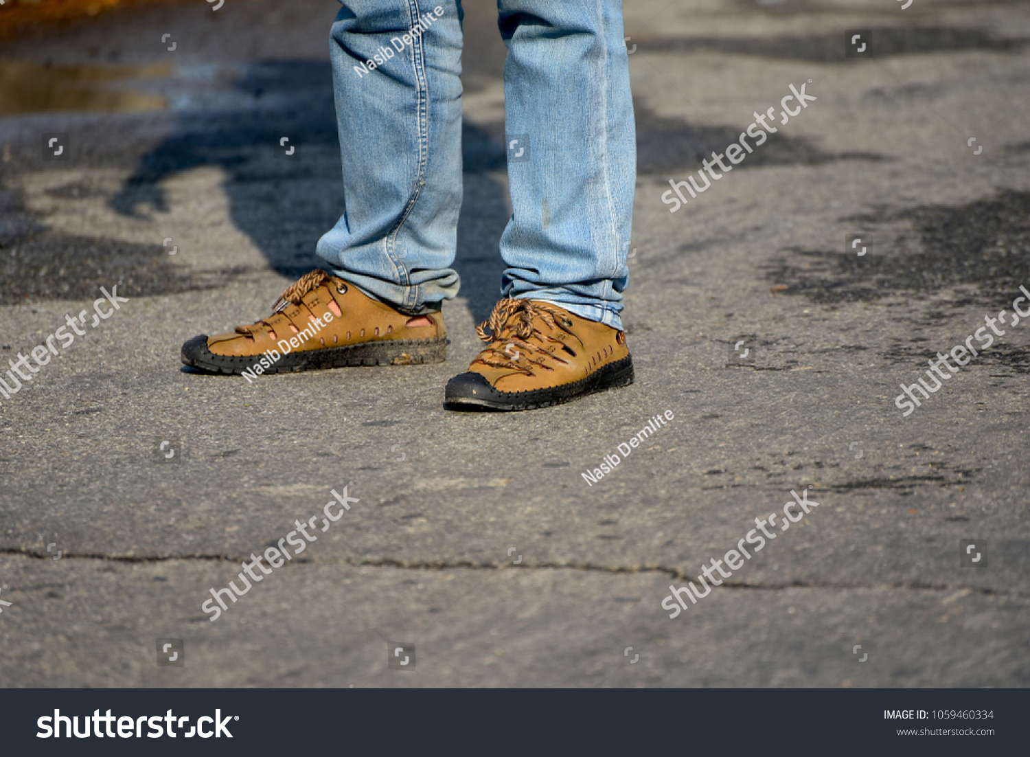 Man standing on a road wearing stylish shoe & jeans wears isolated unique stock photo #1059460334