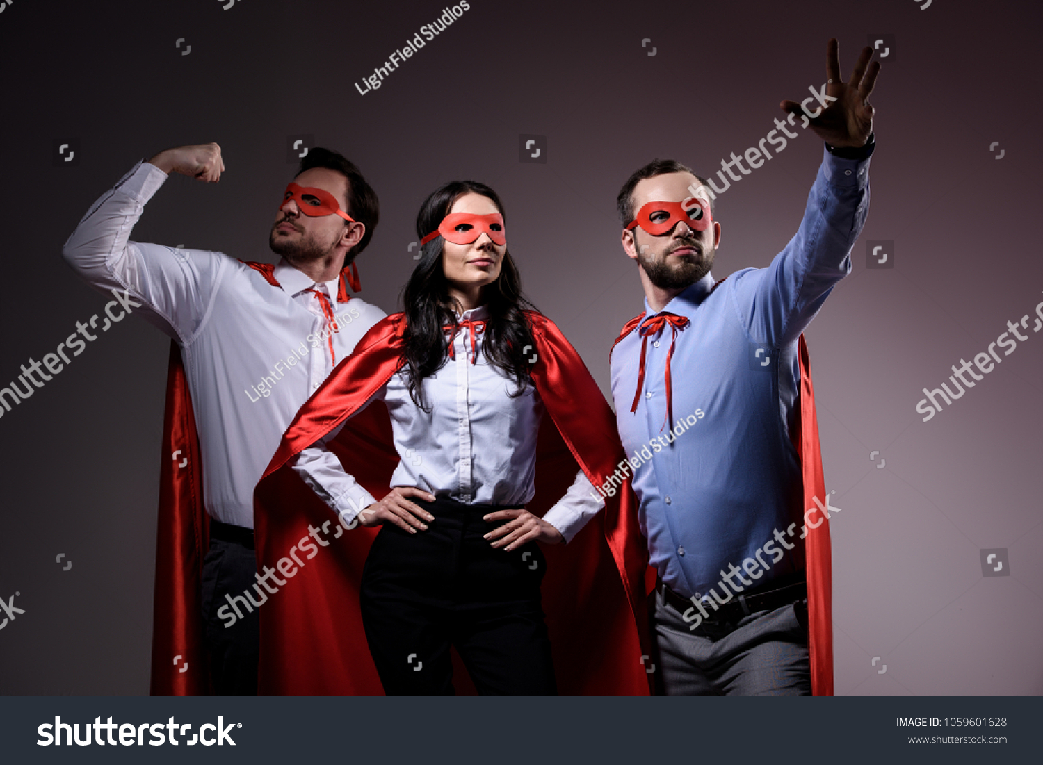super businesspeople in masks and capes showing superpower isolated on grey #1059601628